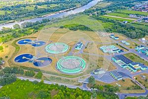 Aerial view of modern water cleaning facility at urban wastewater treatment plant. Purification process of removing undesirable