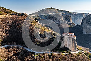 Aerial view of monastery Rousanou and breathtaking picturesque valley and landmark canyon of Meteora at sunset, Kalambaka, Greece