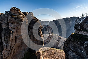 Aerial view of monastery Rousanou and breathtaking picturesque valley and landmark canyon of Meteora at sunset, Kalambaka, Greece