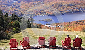 Aerial view of Mont Tremblant Lake with autumn color leaf and red chairs on the foreground, Quebec