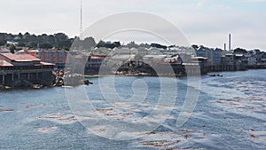 Aerial view of the Monterey Bay Aquarium, Pacific Grove with many yachts docked