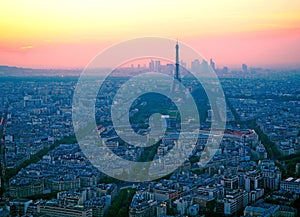 Aerial view, from Montparnasse tower at sunset, view of the Eiffel Tower and La Defense district in Paris, France.