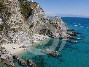 Aerial view of moored boats floating on a transparent sea. Scuba diving and summer holidays. Capo Vaticano, Calabria, Italy