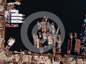 Aerial view of moored old barges and ships in river port