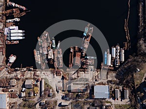 Aerial view of moored old barges and ships in river port