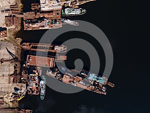 Aerial view of moored old barges and ships in river port