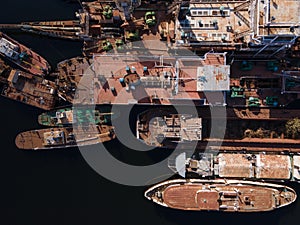 Aerial view of moored old barges and ships in river port