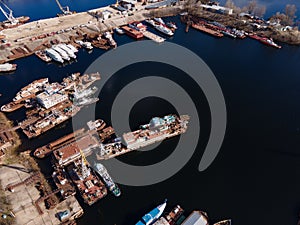 Aerial view of moored old barges and ships in river port