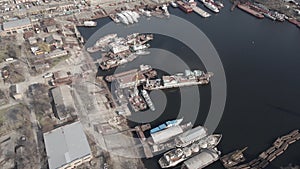 Aerial view of moored old barges and ships in river port