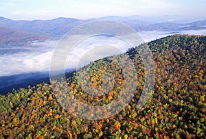 Aerial view of morning fog over mountains near Stowe, VT in autumn along Scenic Route 100