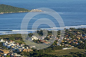 Aerial view of waves breaking from the top o Morro do LampiÃÂ£o at Campeche beach in Florianopolis Brazil photo