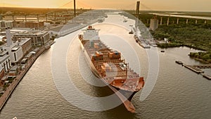 Aerial view of a mostly empty container ship leaving the port of Savannah, Georgia, USA