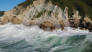 Aerial view of motion waves crashing against rocks ocean's power Waves relentlessly meet rocks dance of nature