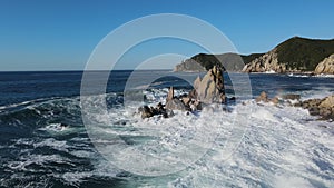 Aerial view of motion waves crashing against rocks ocean's power Waves relentlessly meet rocks dance of nature