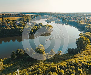 Aerial view of motor boat on river. Drone photography