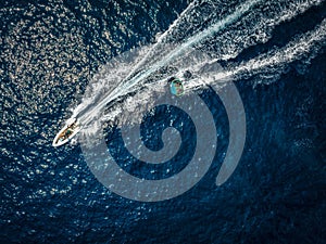 Aerial view of a motor speeboat towing a watersports