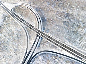 Aerial view of a motorway intersection in the snowconvert winter landscape