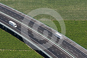 Aerial view of motorway with two white trucks