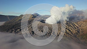 Aerial view of Mount Bromo volcano covered with thick mist at sunrise, Surabaya, Java, Indonesia