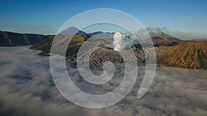 Aerial view of Mount Bromo volcano covered with thick mist at sunrise, Surabaya, Java, Indonesia