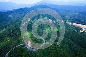 Aerial view of mountain asphalt road and dirt road