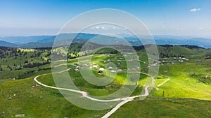 Aerial View of Mountain Cottages on Green Hill of Velika Planina Big Pasture Plateau, Alpine Meadow Landscape, Slovenia