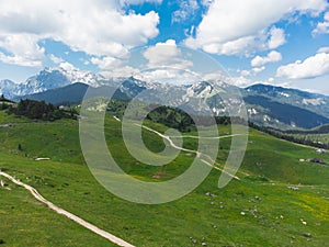 Aerial View of Mountain Cottages on Green Hill of Velika Planina Big Pasture Plateau, Alpine Meadow Landscape, Slovenia