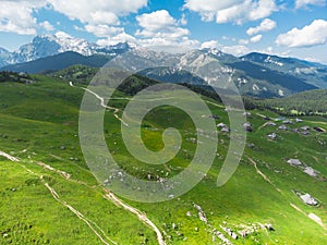 Aerial View of Mountain Cottages on Green Hill of Velika Planina Big Pasture Plateau, Alpine Meadow Landscape, Slovenia