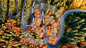 Aerial view of mountain curved road with truck heavy traffic. Asphalt serpentine roads details