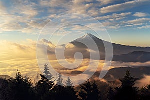 Aerial view of Mountain Fuji with morning mist or fog at sunrise