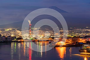 Aerial view of Mountain Fuji near industrial area, factory, Japanese port and harbour in Shizuoka City at sunset, Japan. Natural