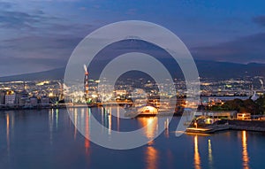 Aerial view of Mountain Fuji near industrial area, factory, Japanese port and harbour in Shizuoka City at sunset, Japan. Natural