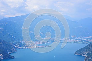 Aerial view of mountain lake Iseo, forested mountains, various villages scattered along the slopes and along the coast