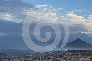 Aerial view of mountain in the morning. Mountains in fog and clouds with stones and rocks foreground.