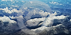 Aerial view of mountain range with snow covered peaks