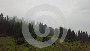 Aerial view of a mountain road that rises during the morning fog