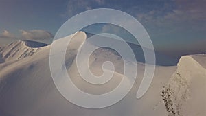 Aerial view of mountain snow-capped peak, at sunrise