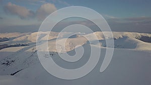 Aerial view of mountain snow-capped peak, at sunrise