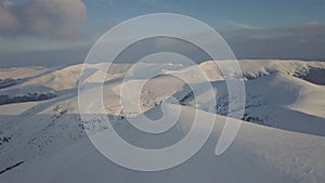 Aerial view of mountain snow-capped peak, at sunrise