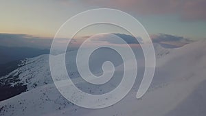 Aerial view of mountain snow-capped peak, at sunrise