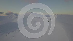 Aerial view of mountain snow-capped peak, at sunrise