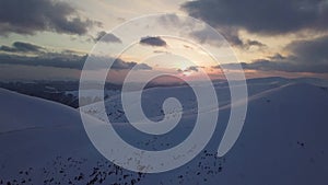 Aerial view of mountain snow-capped peak, at sunset