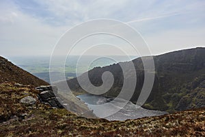 aerial view from a mountain to a lake coming from a glacier. Comeragh Mountains, Waterford, Ireland