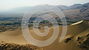 Aerial view mountain valley with sand dune desert ripple cliff ridge natural landscape drone shot