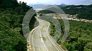 Aerial view of a mountain winding road and distant city of Marmaris, Turkey