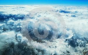 Aerial view of mountains and clouds on top