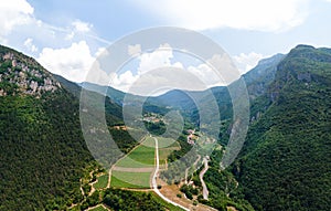 Aerial view of mountains Dietrobeseno and Sant Andrea northern vineyards, vine fields production and industry in Besenello, Trento
