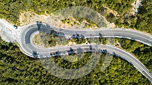 Aerial view of the movement of vehicles on a serpentine mountain road. Croatia