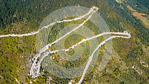 Aerial view of the movement of vehicles on a serpentine mountain road. Croatia
