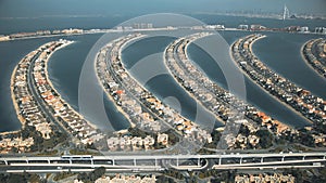 Aerial view of moving monorail train and fronds of the Palm Jumeirah island, United Arab Emirates